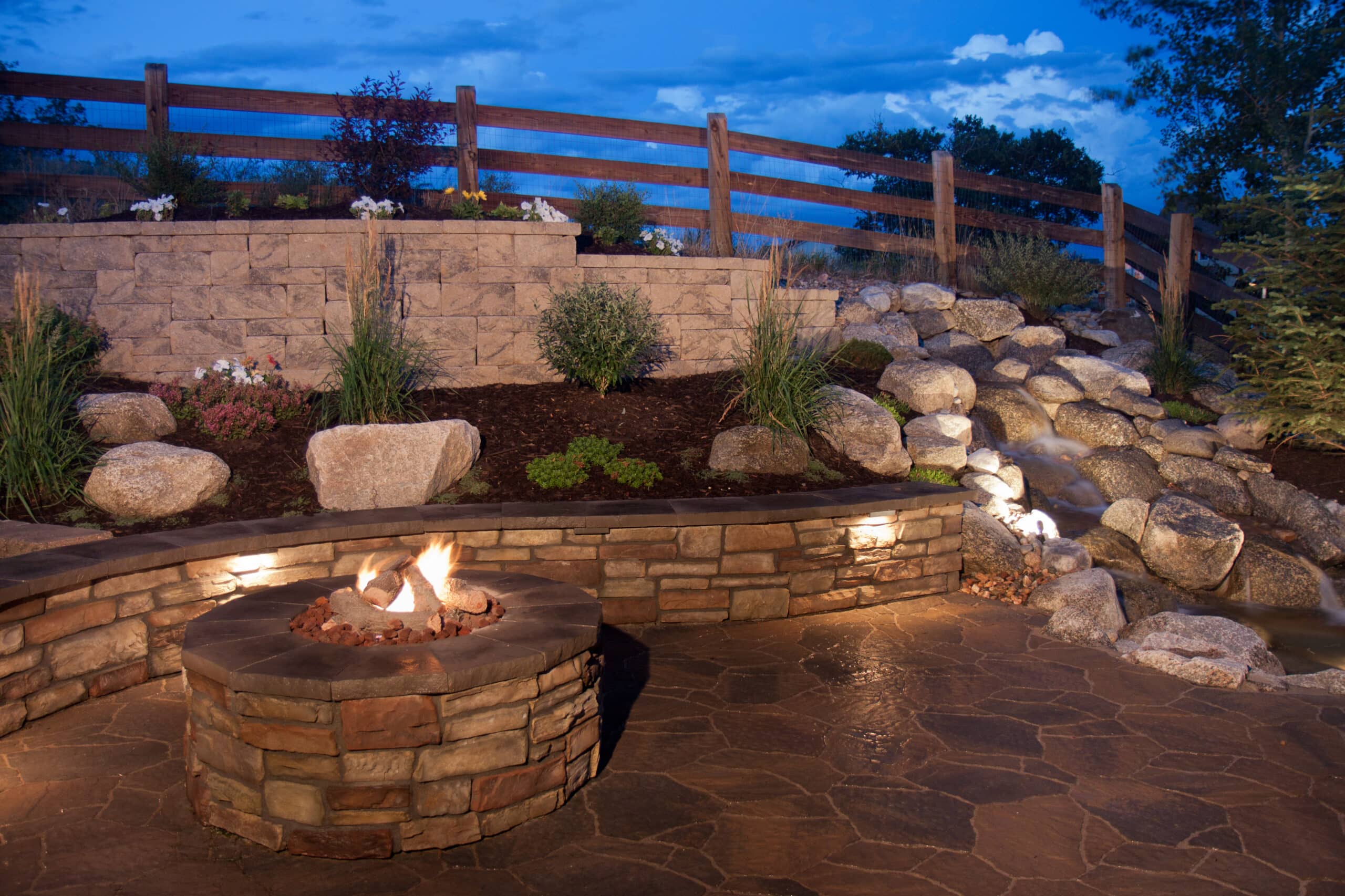 Beautiful Backyard Fire Pit and Seat Wall Composite Decking stairs with lights in San Antonio